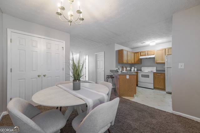 dining room featuring a chandelier, a textured ceiling, and baseboards