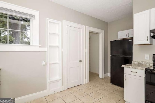 1709 Rogers Ave SW, Atlanta, GA 30310 - kitchen with baseboards, white cabinetry, black appliances, and light tile patterned floors