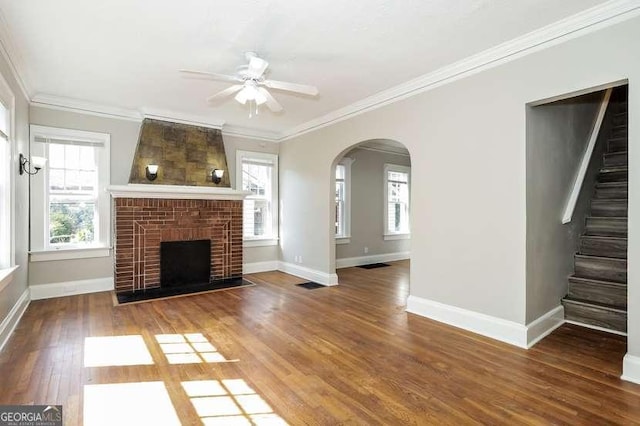 1709 Rogers Ave SW, Atlanta, GA 30310 - unfurnished living room featuring baseboards, arched walkways, ornamental molding, wood finished floors, and stairs