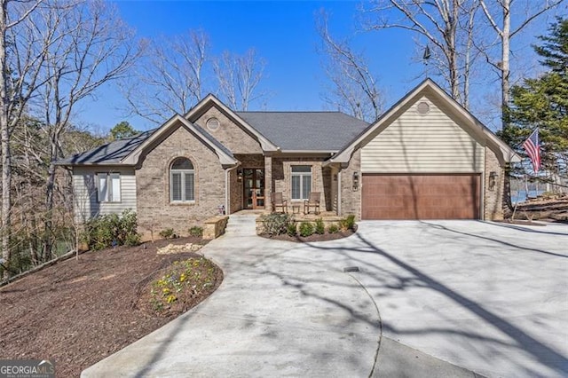 ranch-style home with a garage, brick siding, and driveway