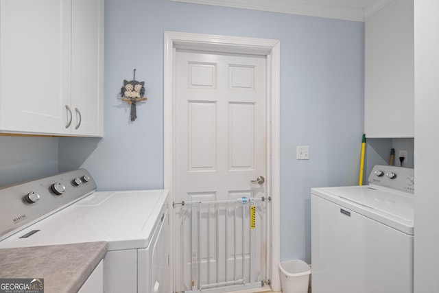 laundry area featuring cabinet space, ornamental molding, and separate washer and dryer