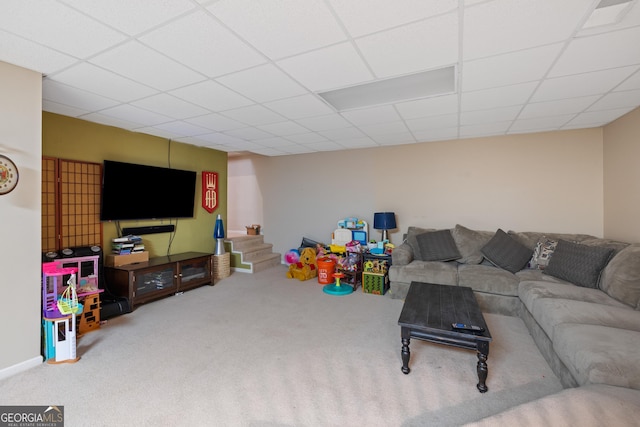 living area with stairs, carpet flooring, and a paneled ceiling