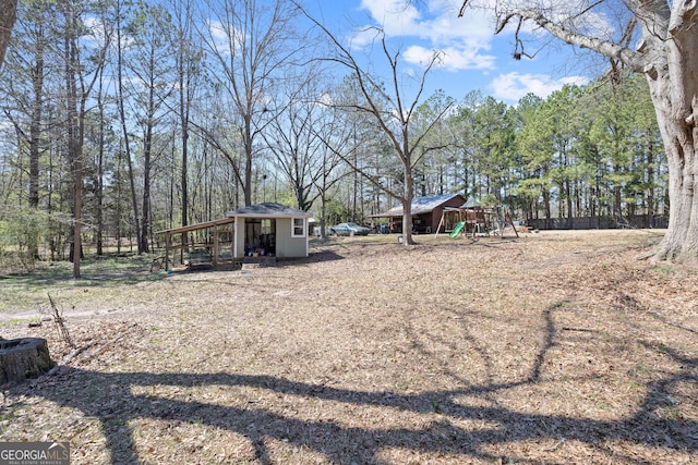 view of yard featuring an outdoor structure and a playground