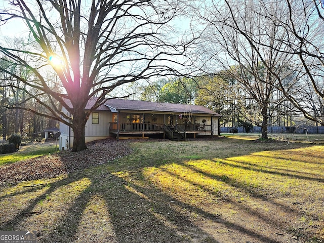 back of house with a yard and a deck