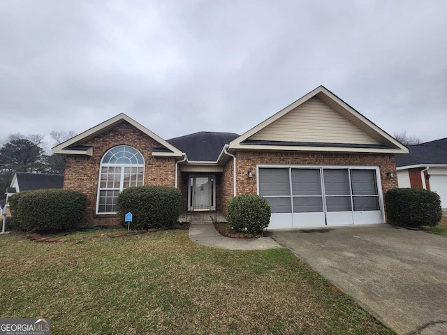 ranch-style home featuring driveway, brick siding, a front lawn, and an attached garage