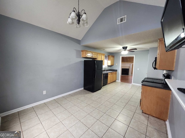 kitchen featuring visible vents, ceiling fan with notable chandelier, black appliances, a fireplace, and light tile patterned flooring