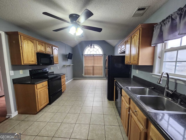 kitchen featuring dark countertops, visible vents, light tile patterned flooring, a sink, and black appliances