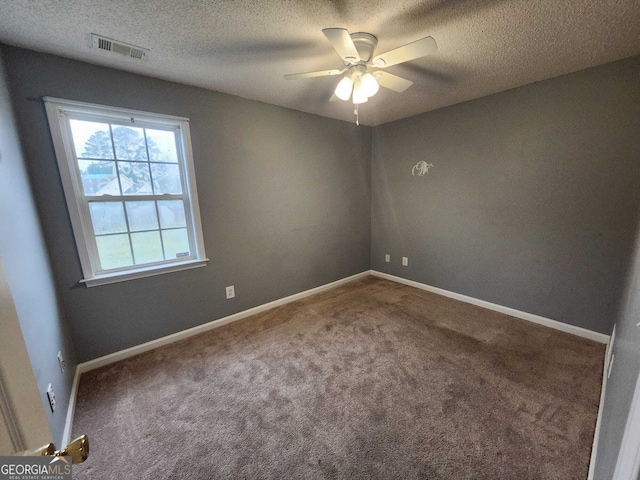 empty room with a ceiling fan, carpet, visible vents, and baseboards