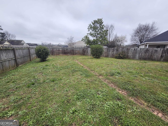 view of yard with a fenced backyard