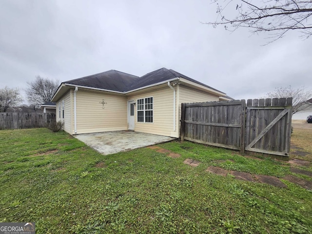 back of property featuring a patio area, fence, and a yard