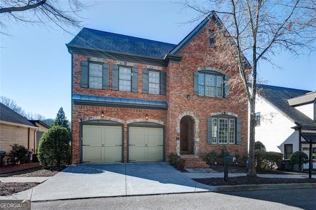 view of front of property with concrete driveway, a garage, and brick siding