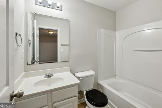 bathroom with toilet, washtub / shower combination, and vanity