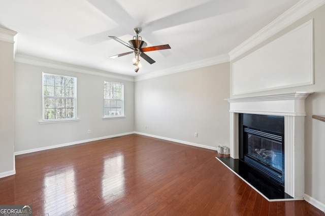 unfurnished living room featuring a glass covered fireplace, dark wood-style flooring, and crown molding