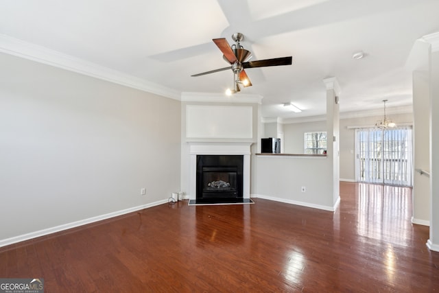 unfurnished living room featuring baseboards, ornamental molding, wood finished floors, and a glass covered fireplace