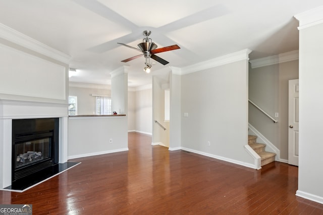 unfurnished living room featuring ornamental molding, a glass covered fireplace, and wood finished floors