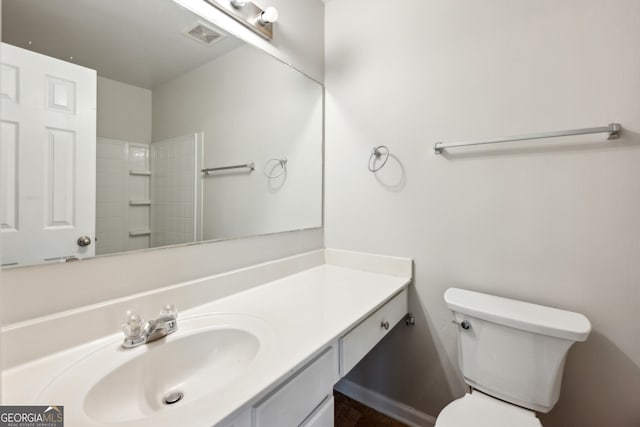 bathroom with toilet, visible vents, and vanity