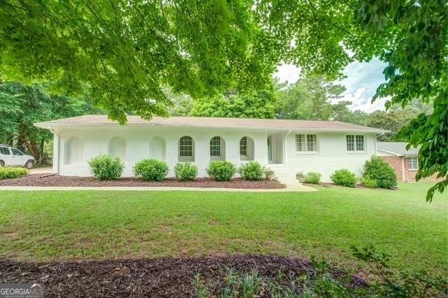 ranch-style house with a front lawn