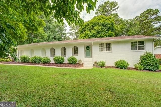 single story home with a front yard and stucco siding