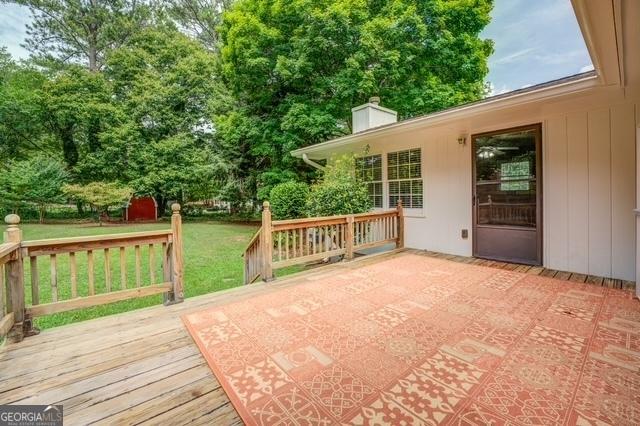 wooden deck featuring a yard