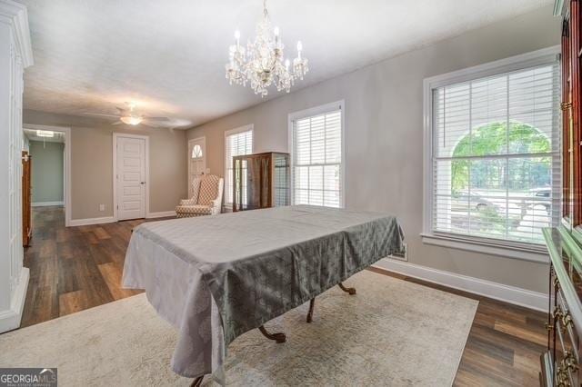 playroom featuring an inviting chandelier, dark wood finished floors, and baseboards