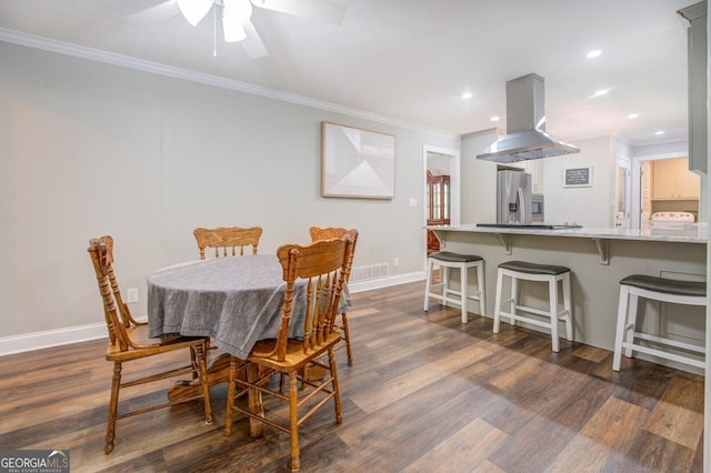 dining room featuring dark wood-style floors and ornamental molding