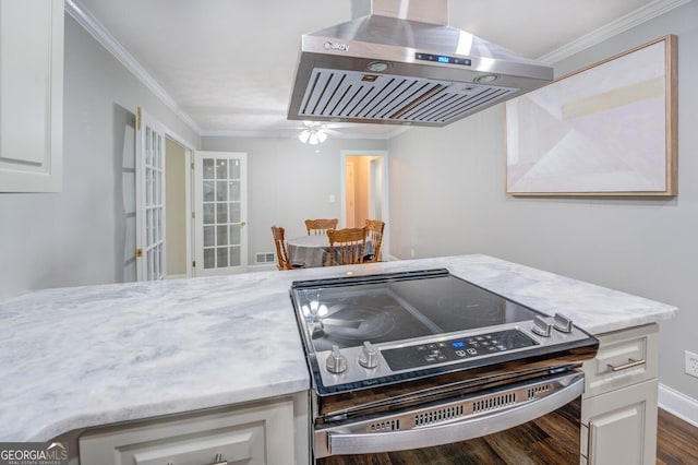 kitchen with ornamental molding, light stone counters, range hood, stainless steel range with electric stovetop, and white cabinetry