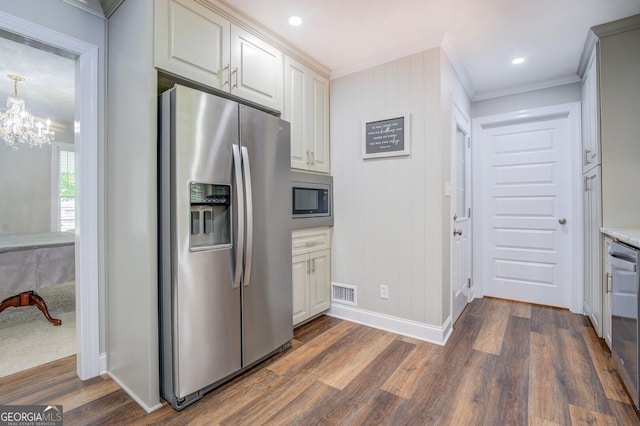 kitchen with visible vents, appliances with stainless steel finishes, dark wood finished floors, and ornamental molding