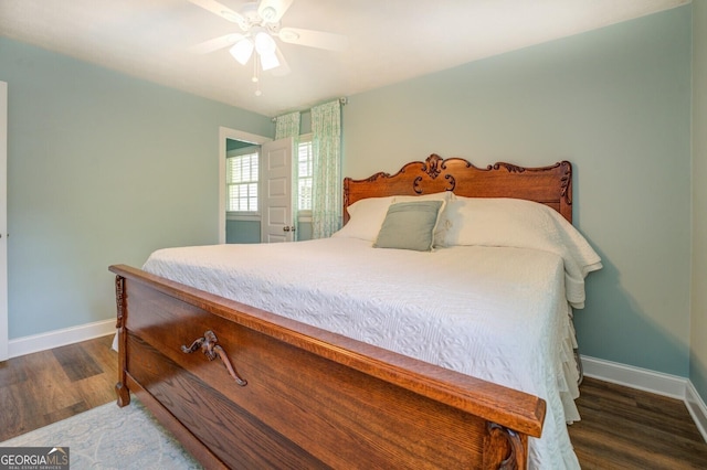 bedroom with ceiling fan, wood finished floors, and baseboards