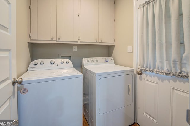 washroom featuring cabinet space and washer and dryer