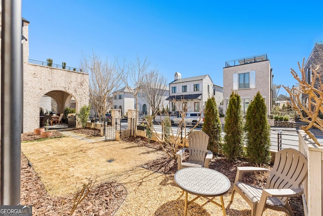 view of patio / terrace featuring fence and a residential view