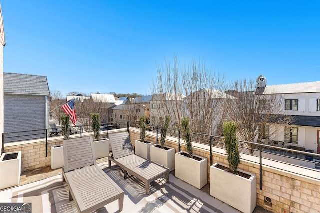 view of patio featuring a residential view and a balcony