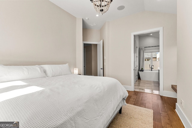 bedroom with lofted ceiling, ensuite bathroom, recessed lighting, baseboards, and hardwood / wood-style floors