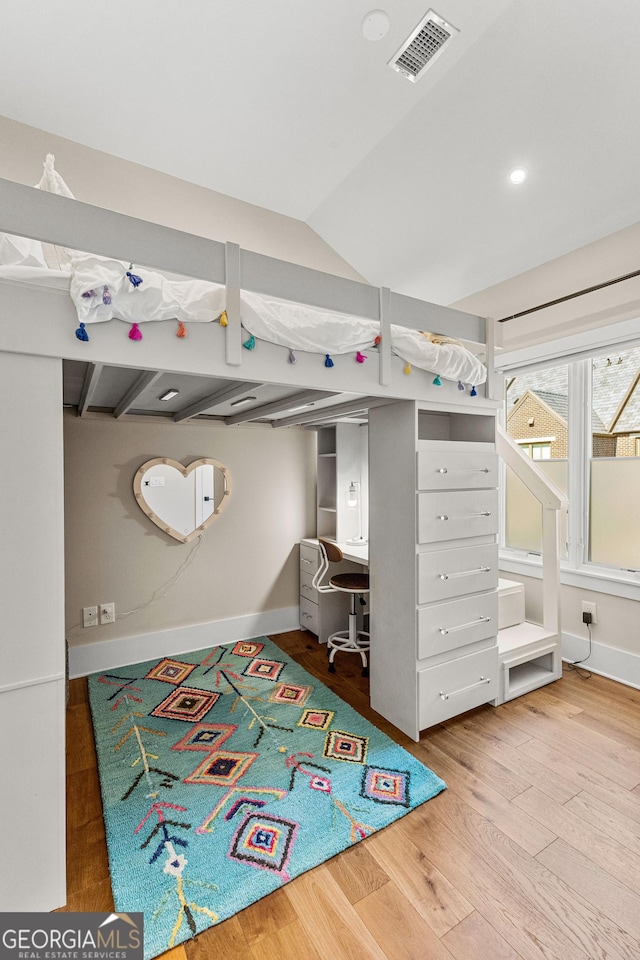 bedroom featuring baseboards, visible vents, lofted ceiling, wood finished floors, and recessed lighting