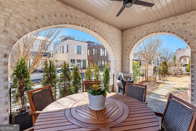 view of patio / terrace with area for grilling, ceiling fan, a residential view, fence, and outdoor dining area