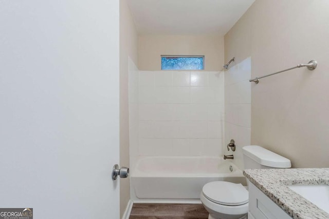 bathroom with vanity, bathtub / shower combination, wood finished floors, and toilet