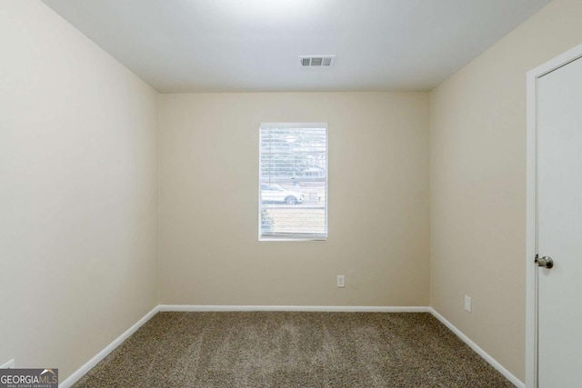 unfurnished room featuring carpet floors, baseboards, and visible vents