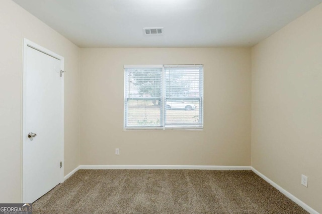 carpeted empty room with visible vents and baseboards