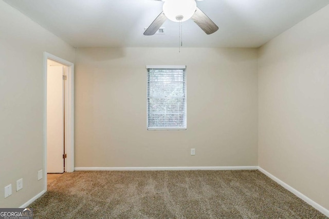 unfurnished room featuring ceiling fan, carpet floors, visible vents, and baseboards