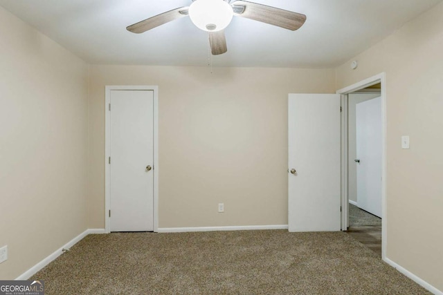 unfurnished bedroom with carpet floors, baseboards, and a ceiling fan