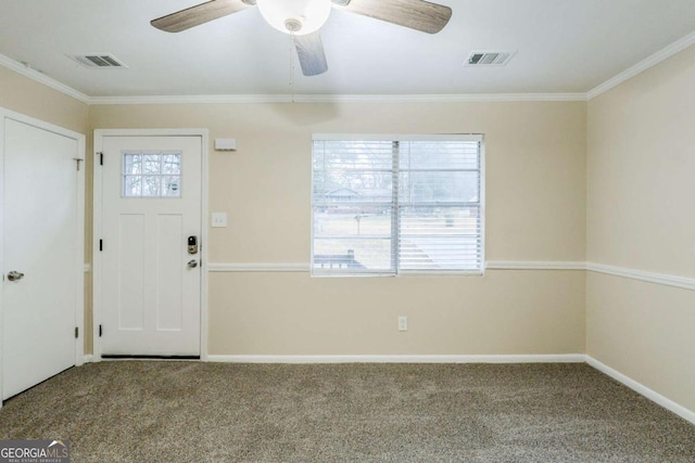 carpeted entrance foyer with ornamental molding, visible vents, and baseboards