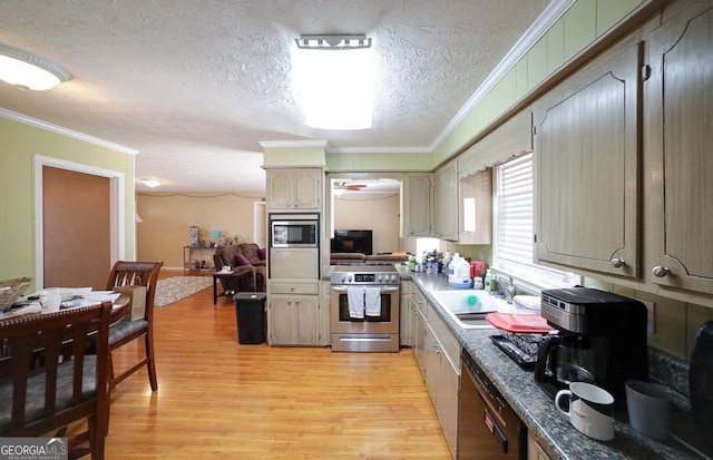 kitchen with appliances with stainless steel finishes, light wood-style floors, ornamental molding, a sink, and a textured ceiling