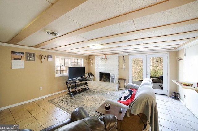 tiled living room featuring french doors, visible vents, a brick fireplace, beamed ceiling, and baseboards