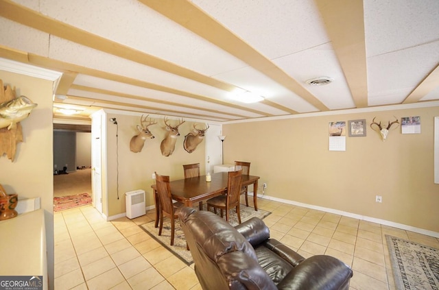 dining room featuring light tile patterned flooring, visible vents, and baseboards