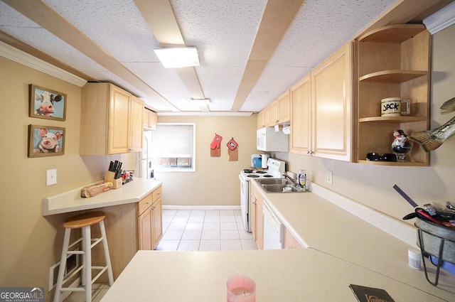 kitchen with white appliances, light tile patterned floors, light countertops, and light brown cabinetry