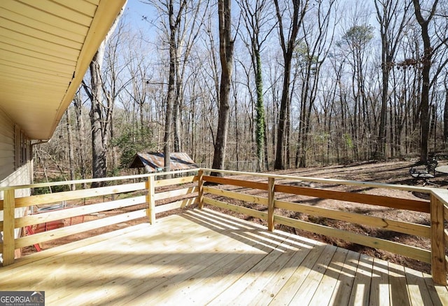 wooden terrace with a wooded view