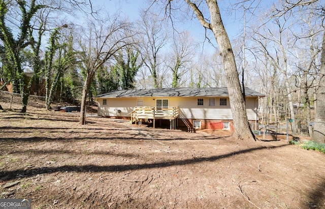 back of house with a deck and fence