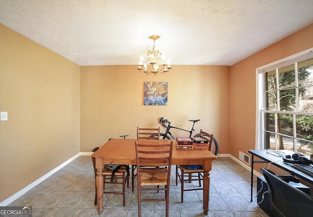 dining area featuring visible vents, a notable chandelier, baseboards, and tile patterned floors