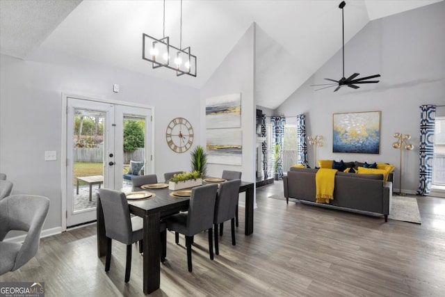 dining space with a wealth of natural light, french doors, and wood finished floors