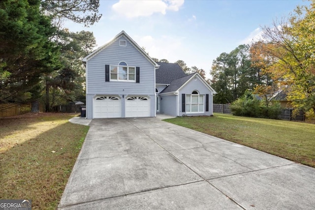 view of front of home with a shingled roof, concrete driveway, an attached garage, fence, and a front lawn