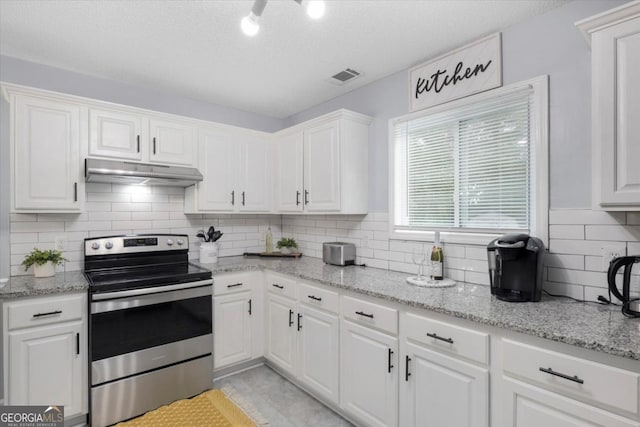 kitchen featuring stainless steel range with electric stovetop, white cabinets, visible vents, and under cabinet range hood